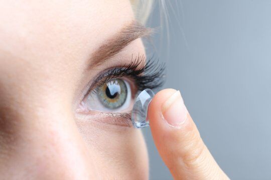 Contact lens being handled