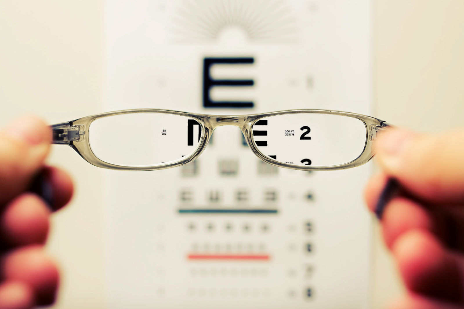 Looking through glasses at an eye chart